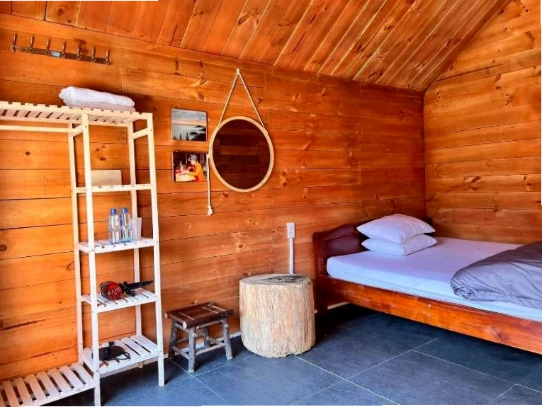 Nội thất phòng ngủ gỗ mộc mạc tại một homestay Tà Xùa